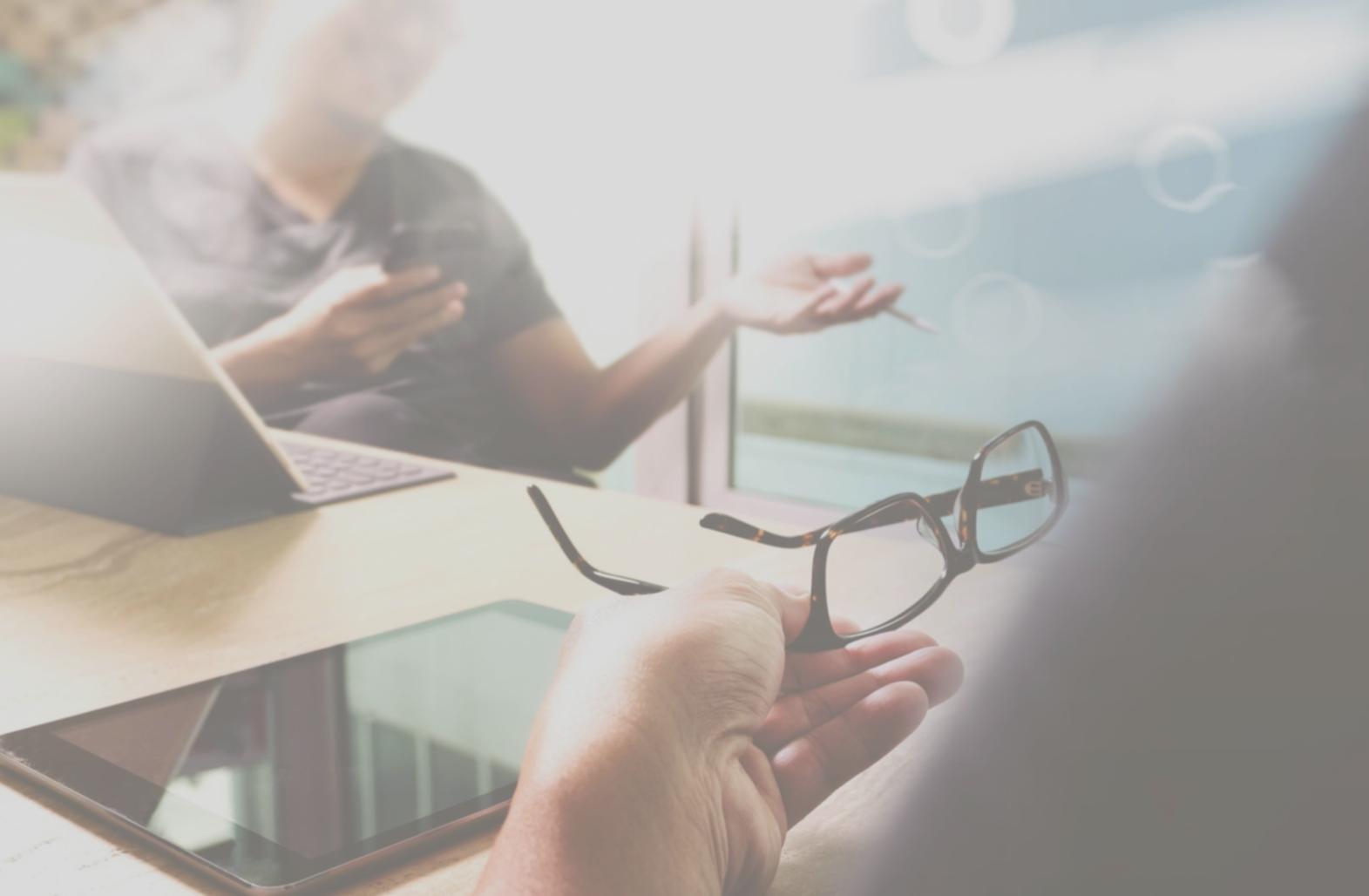 Team collaboration session with developers reviewing mobile game prototypes on tablets